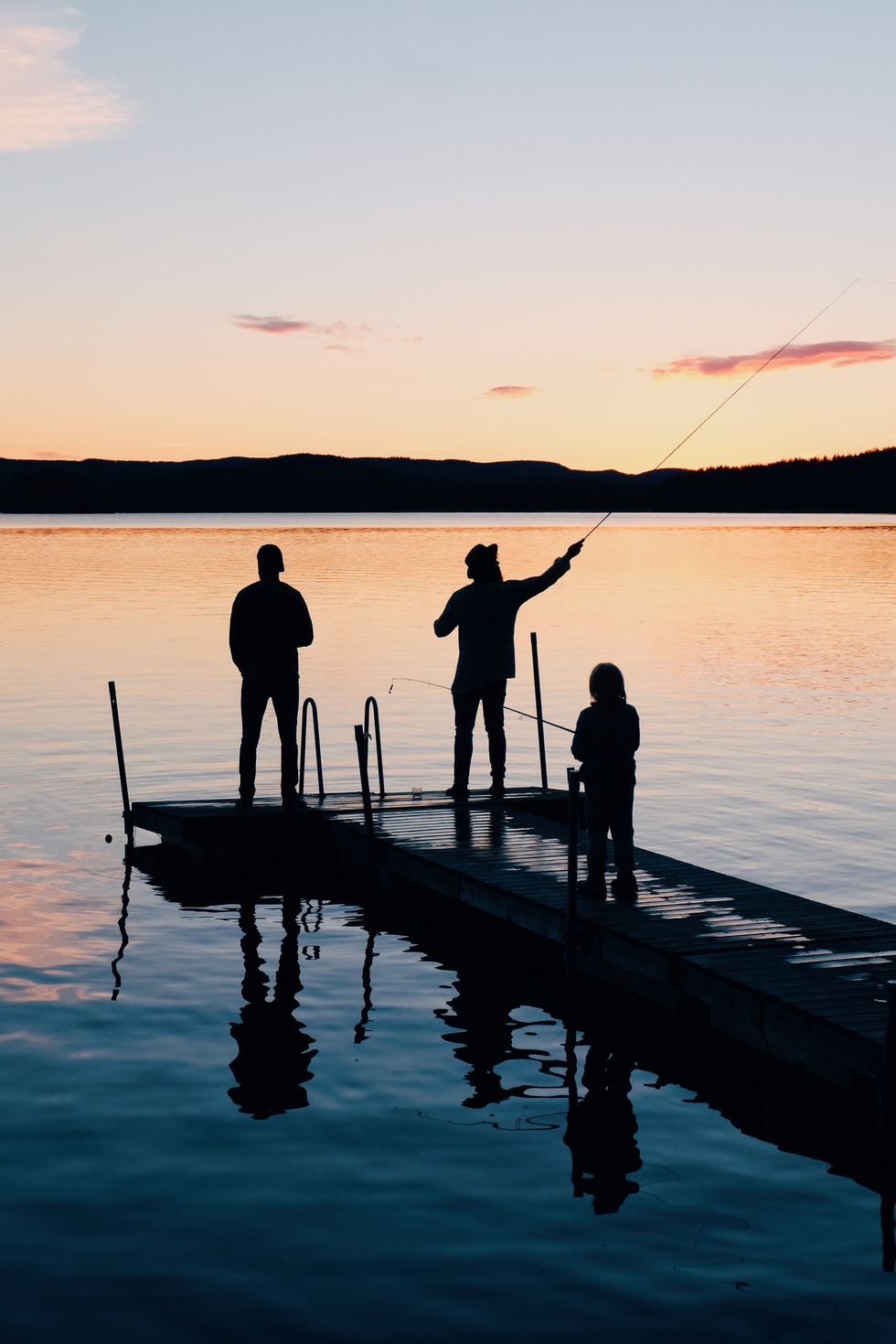 A family on a boat doat at sunset